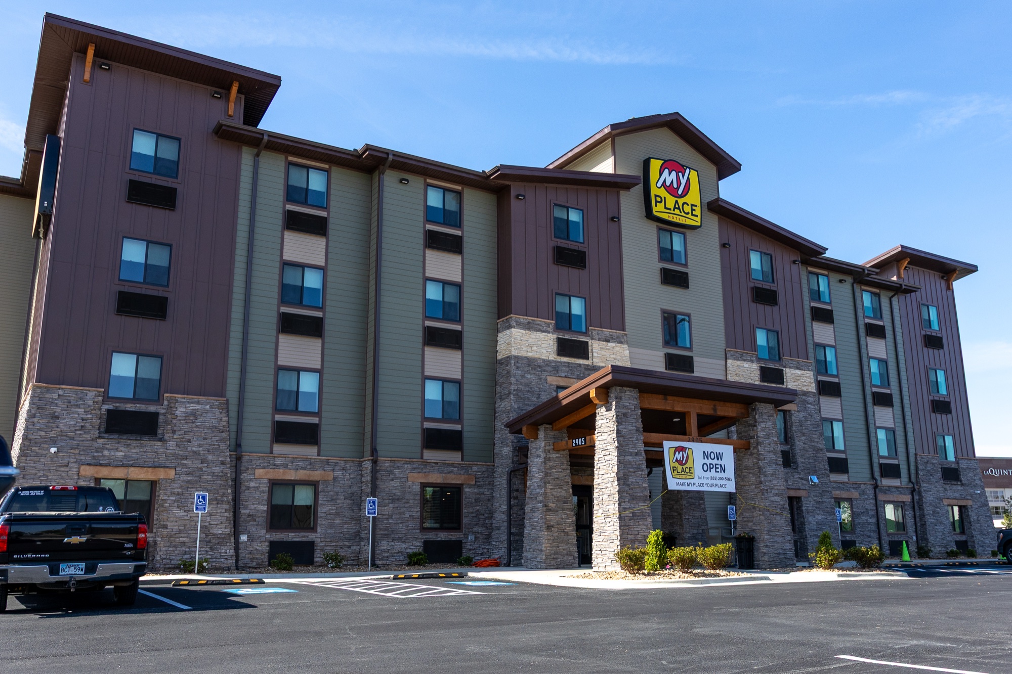Completed My Place Hotel Jonesboro exterior, a four story hotel in Arkansas with stone base and timber entry canopy