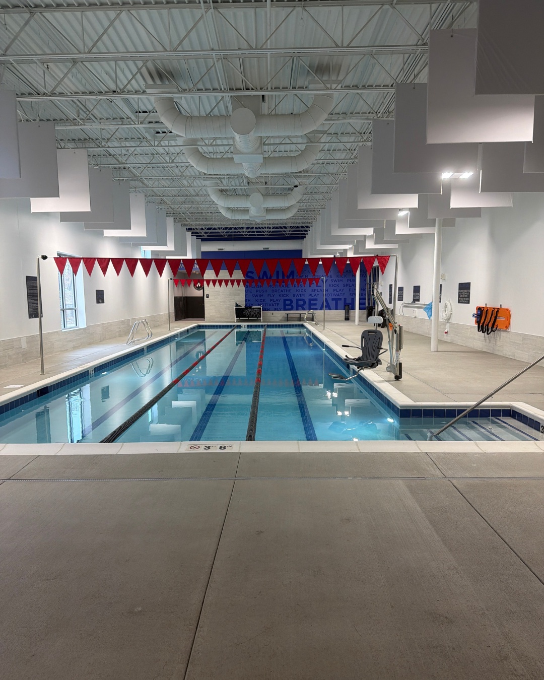 Indoor lap pool with lane lines and pennant flags at VASA Fitness Matteson in Illinois